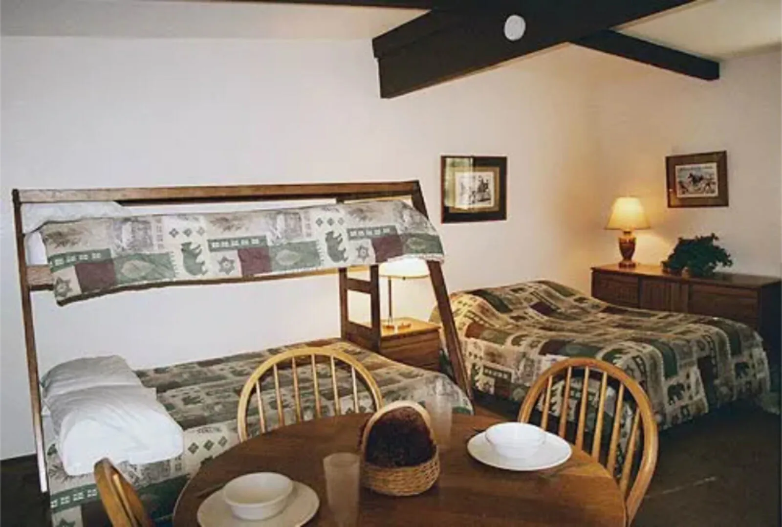 Cabin 3 kitchen and dining area at Silverthorn Resort — full-size refrigerator, electric range, microwave and round dining table in an ADA-accessible Shasta Lake studio cabin