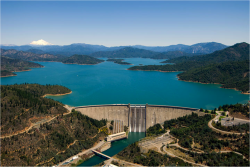 Aerial view of Shasta Dam holding back Shasta Lake with Mount Shasta on the horizon