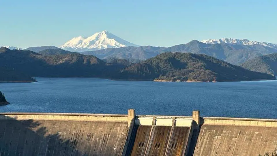 Shasta Dam holding back Shasta Lake with snow-capped Mount Shasta on the horizon