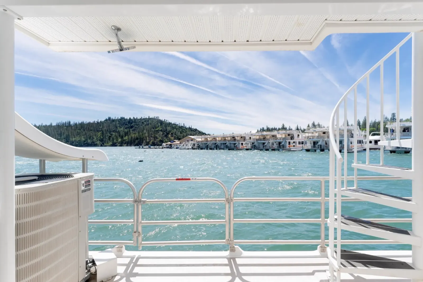 Queen houseboat stern view with waterslide and marina at Silverthorn Resort