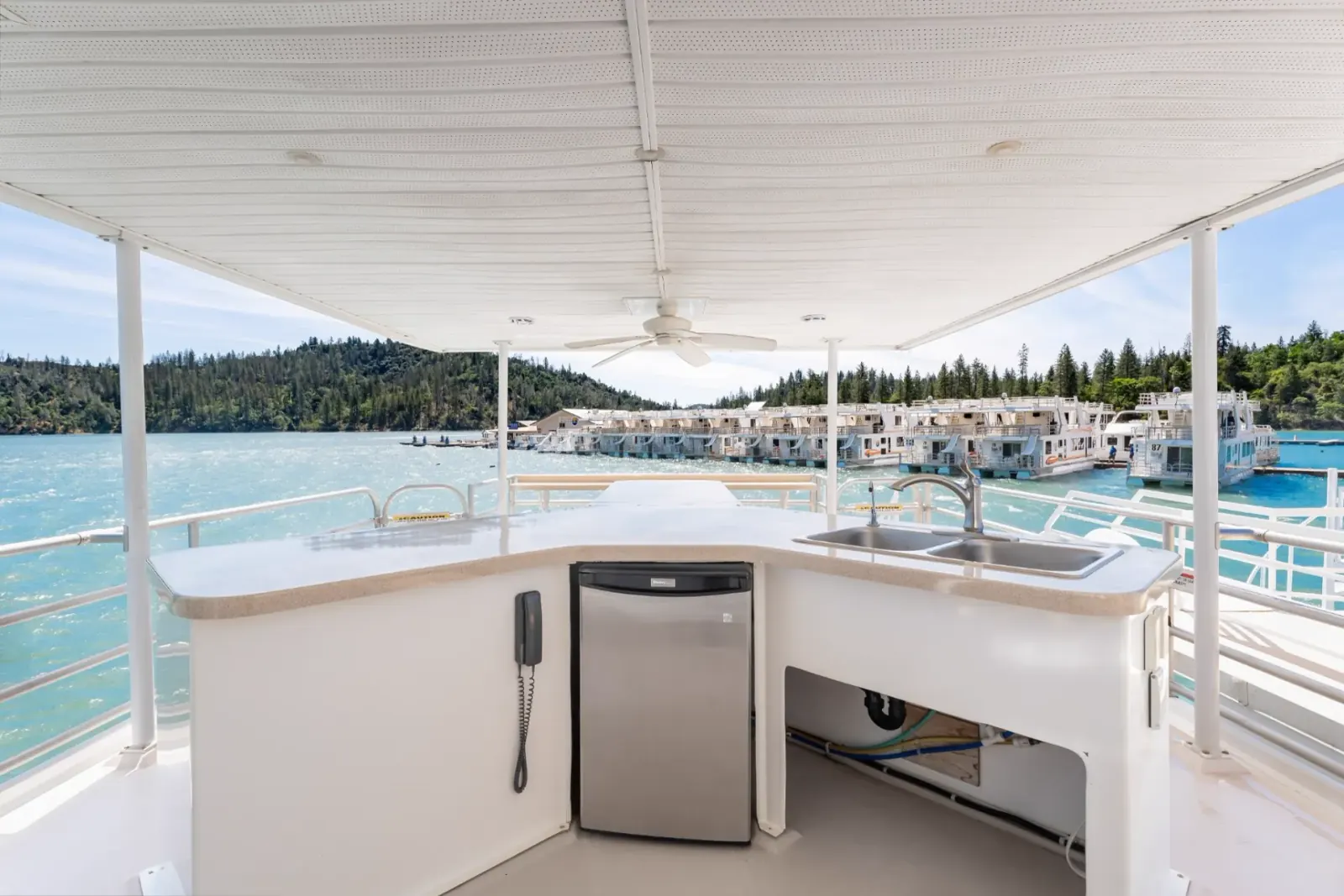Queen houseboat upper deck wet bar counter with sink and refrigerator