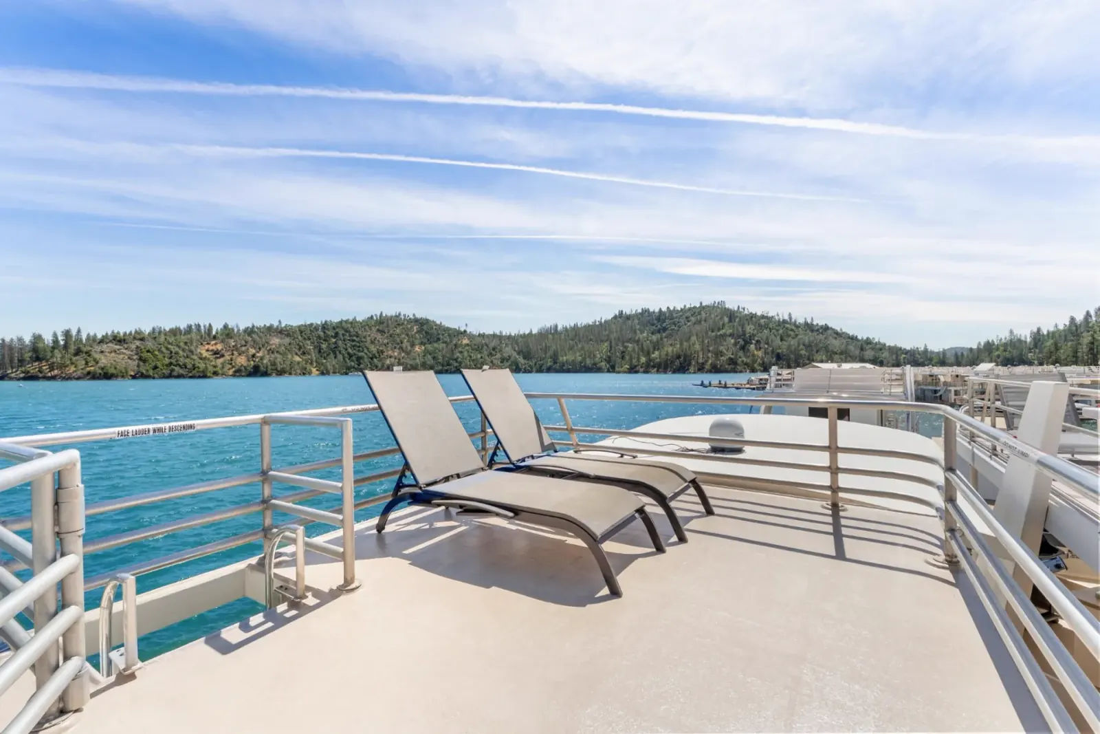 Queen II houseboat sundeck with loungers overlooking Shasta Lake panoramic scenery