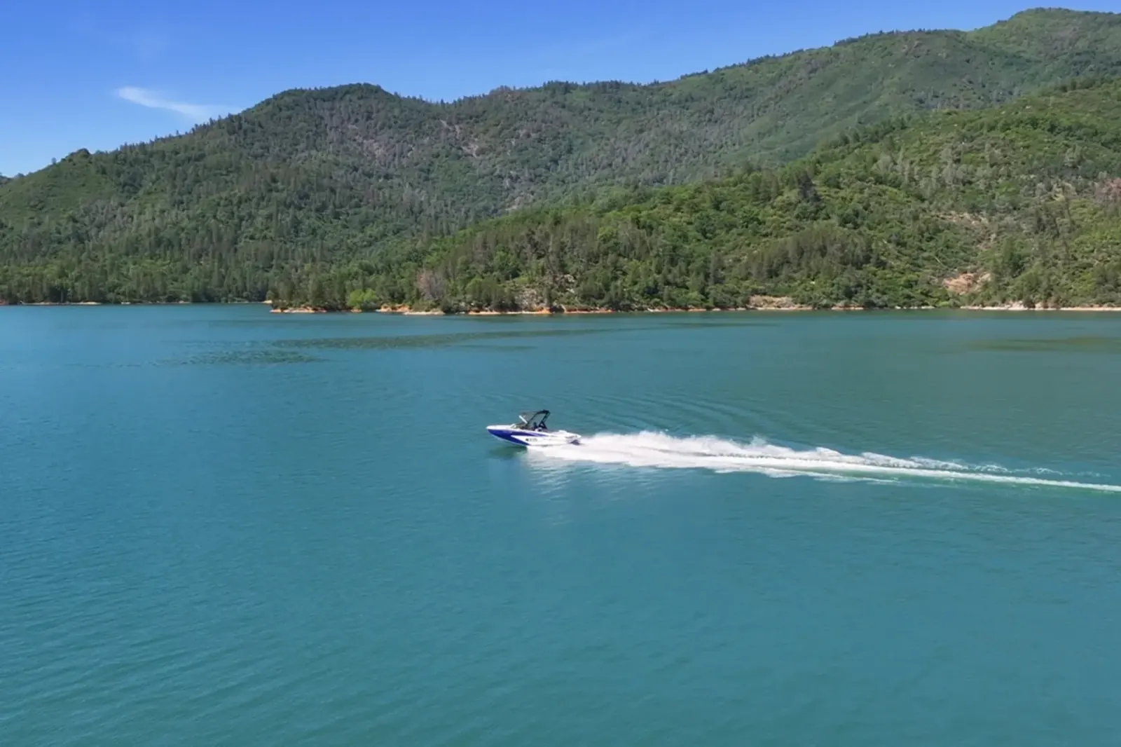 Aerial drone view of Axis T220-R wakeboard boat on open water at Shasta Lake