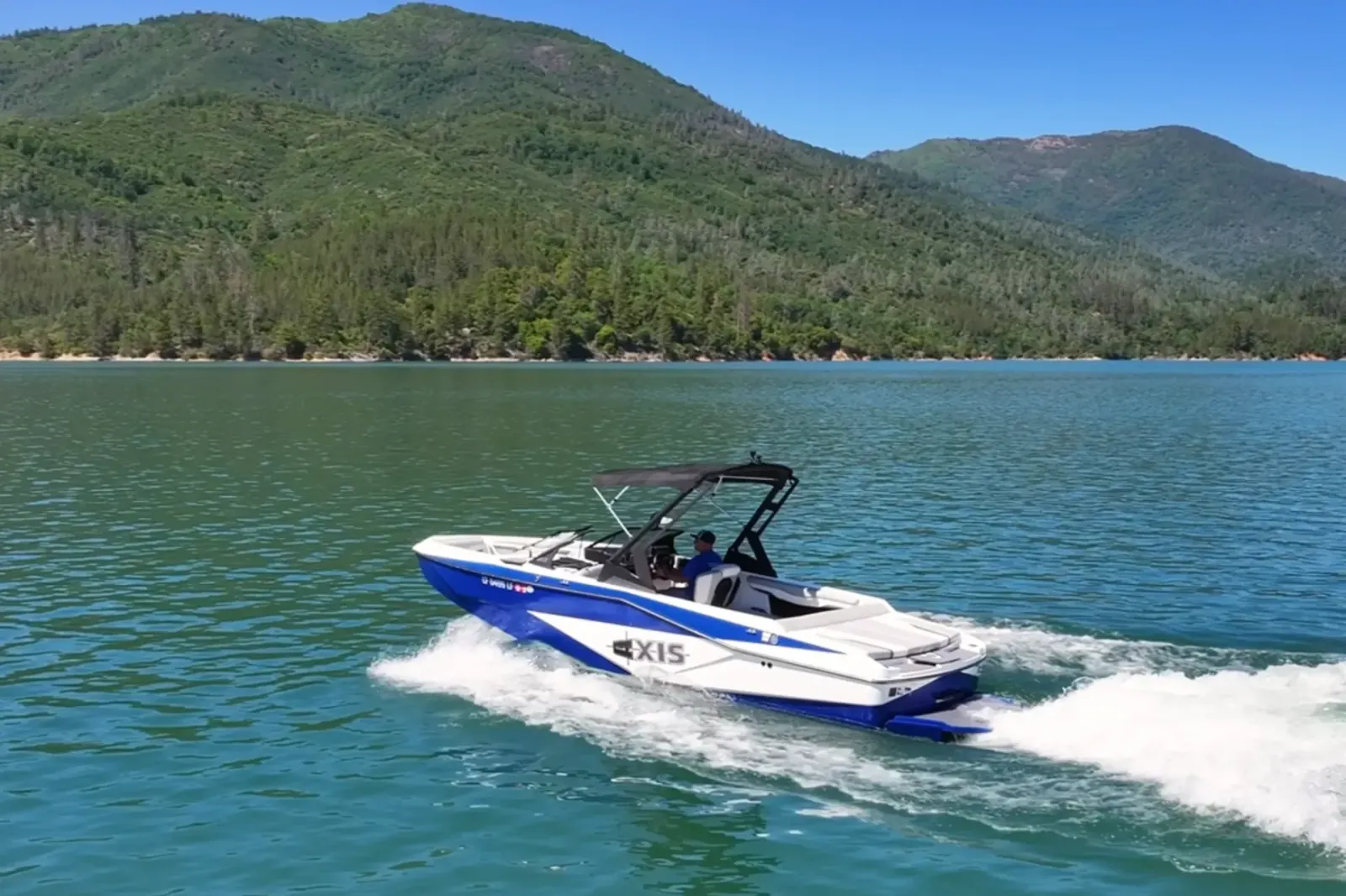 Axis T220-R wakeboard boat cruising with bow view on Shasta Lake near Silverthorn Resort