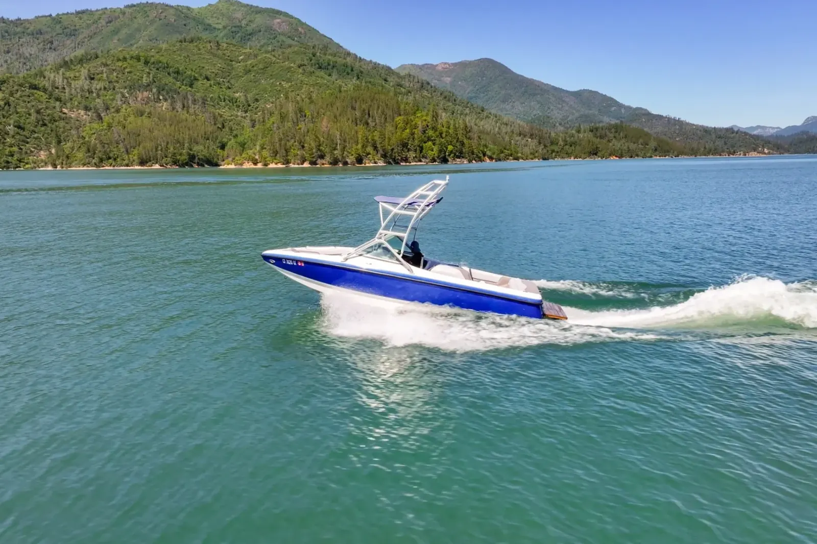 Centurion T-5 wakeboard boat side profile at full speed on open water at Shasta Lake