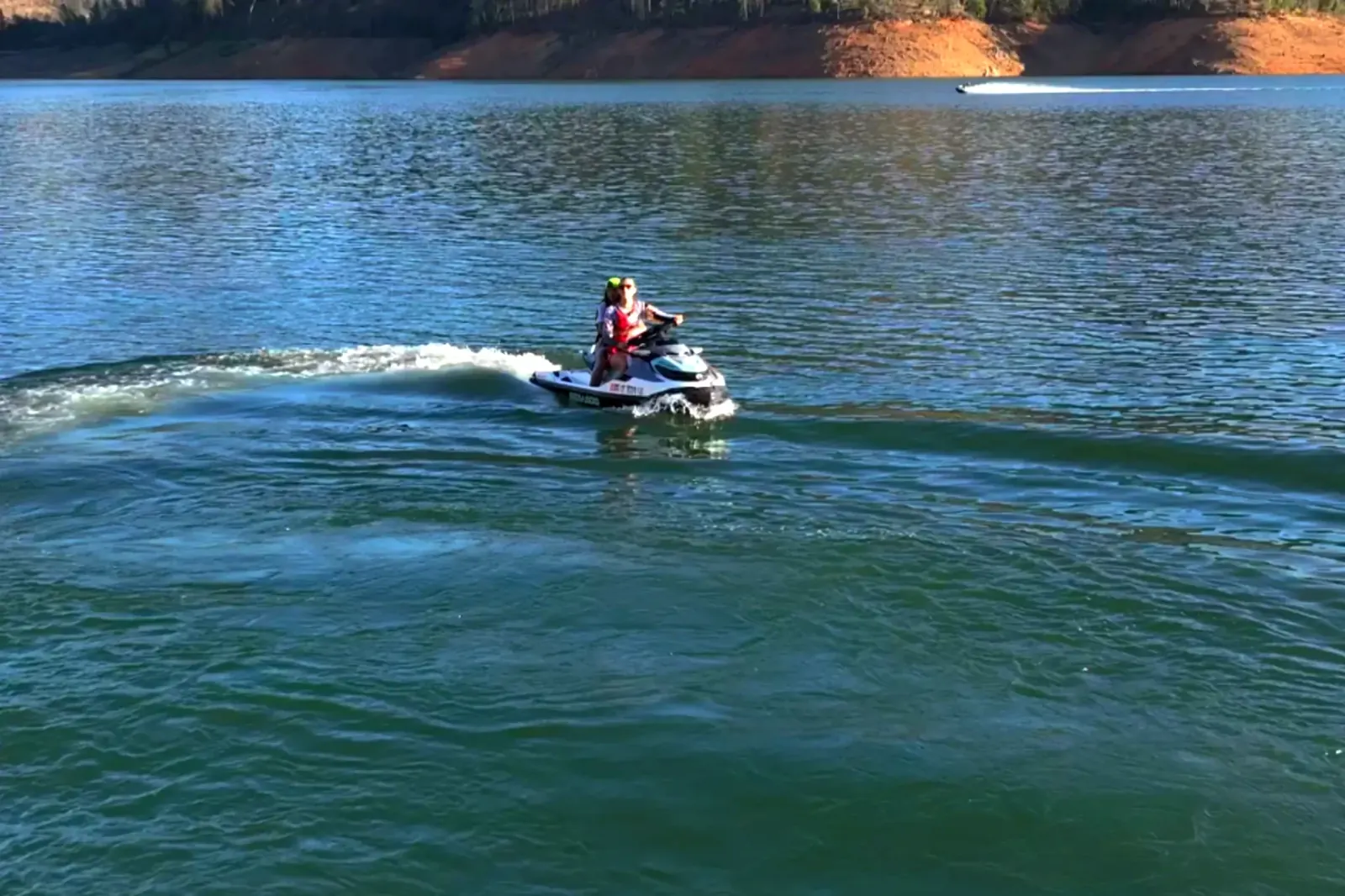 Two riders cruising on a SeaDoo GTX 130 along the Pit River Arm of Shasta Lake