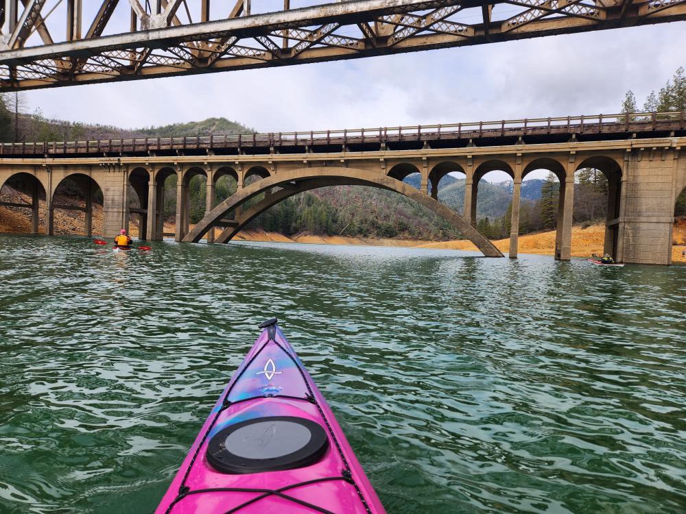 Calm morning kayaking on the glassy waters of Shasta Lake
