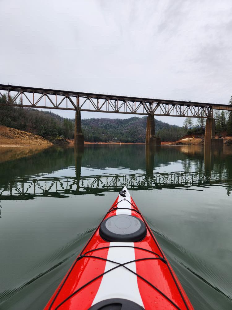 Kayaking with mountain backdrop on Shasta Lake
