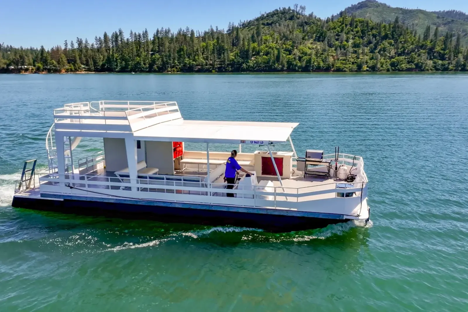 Party Cruiser I side view with upper deck and canopy cruising Shasta Lake