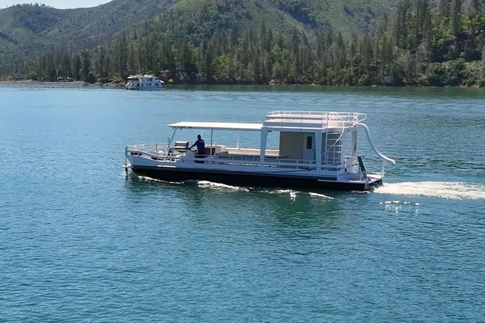 Party Cruiser I wide shot with waterslide on open Shasta Lake waters near Pit River Arm