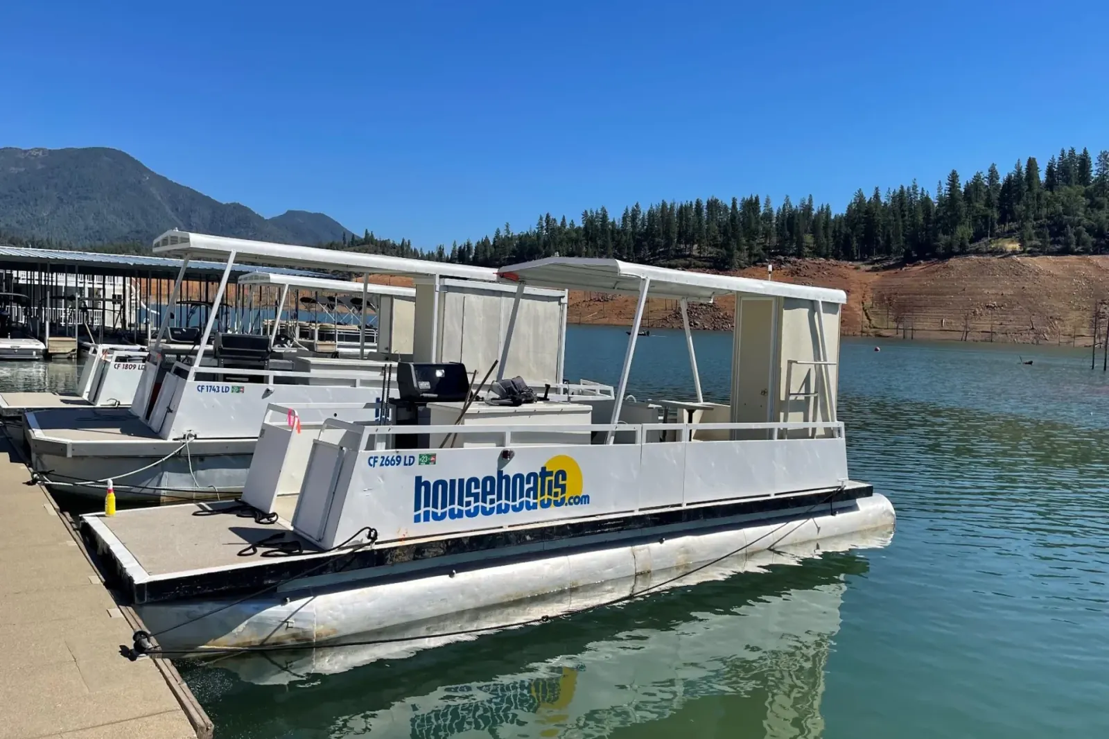Patio Boat with bathroom docked at Shasta Lake marina