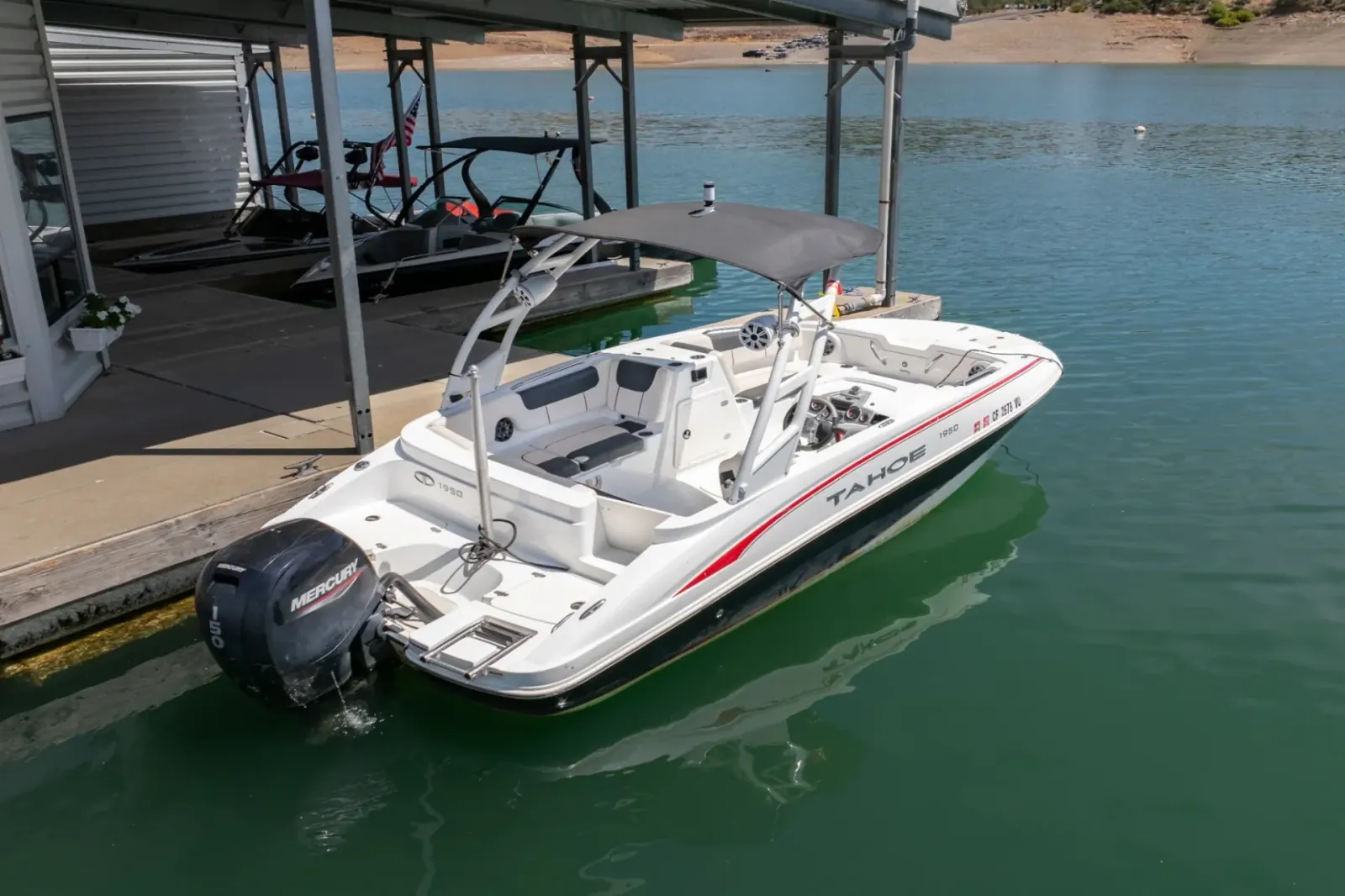 Tahoe Deck Boat 150 stern view with Mercury 150 outboard docked at Silverthorn Resort on Shasta Lake