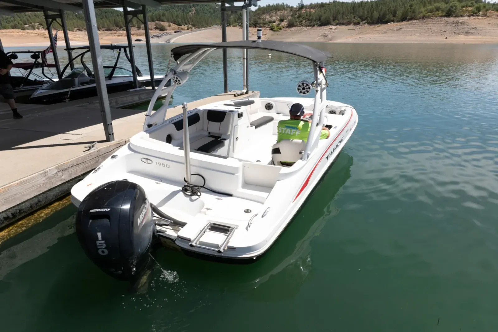 Tahoe Deck Boat 150 stern with staff preparing boat at Silverthorn Resort marina on Shasta Lake